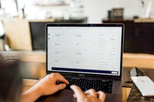 person interacting with an accounting system on a laptop
