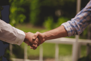 Image of two arms shaking hands