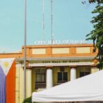 image of Davao City Hall on a sunny day with a Philippine flag visible