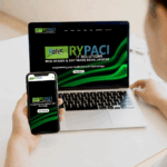 Woman holding a smartphone beside a laptop for mobile-friendly website design