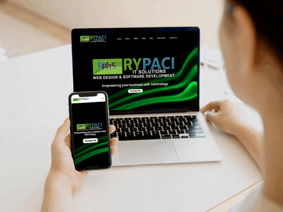 Woman holding a smartphone beside a laptop for mobile-friendly website design