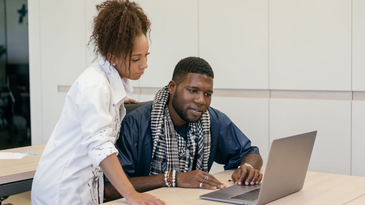 Business professionals comparing website design and custom software on a laptop